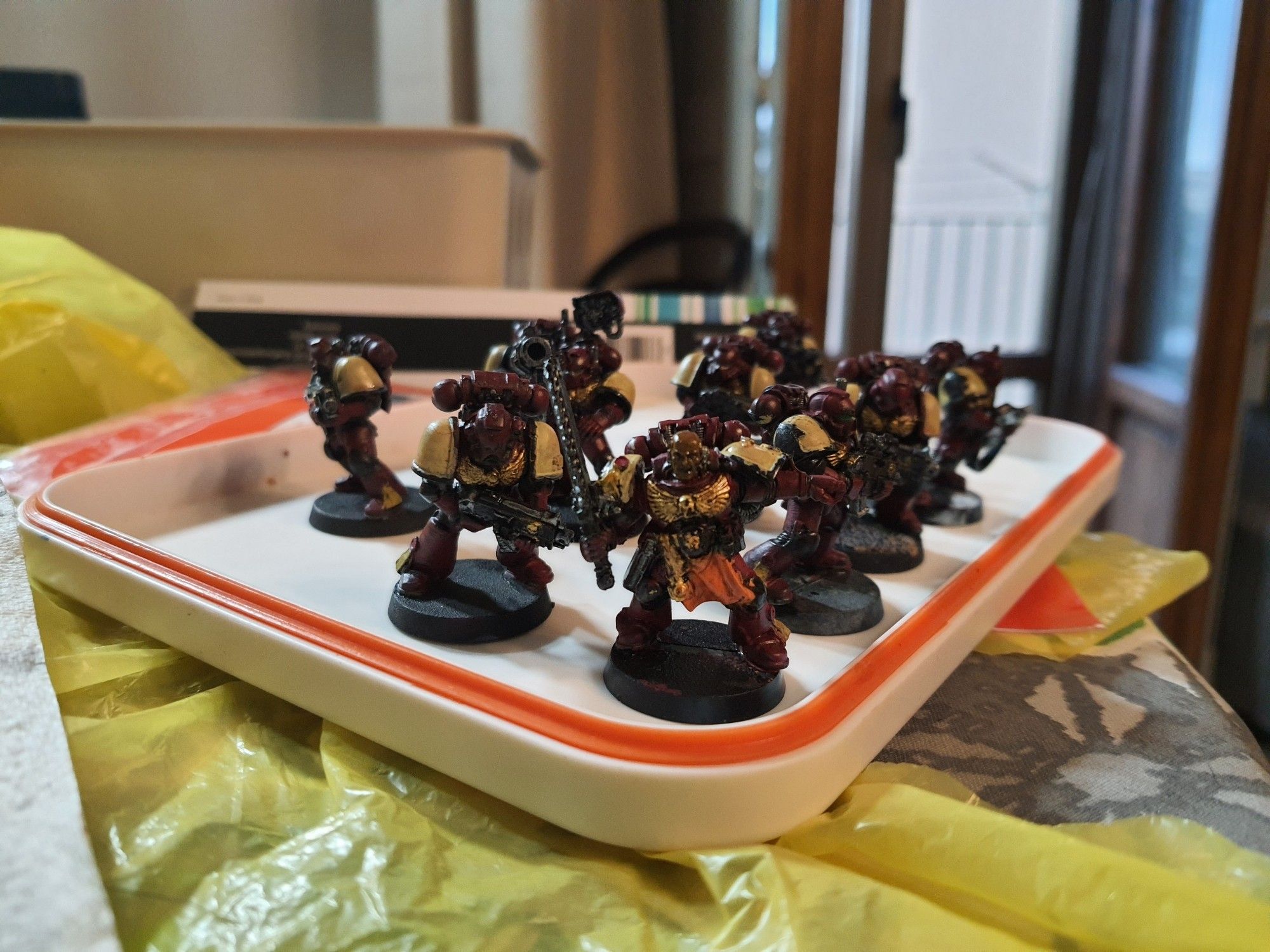 A tactical squad of Space Marines from Warhammer 40k, painted in the colours of the Blood Ravens chapter (red and tan)